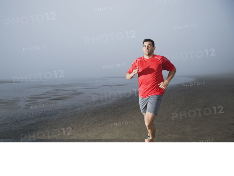 Man jogging on foggy beach. Date: 2008