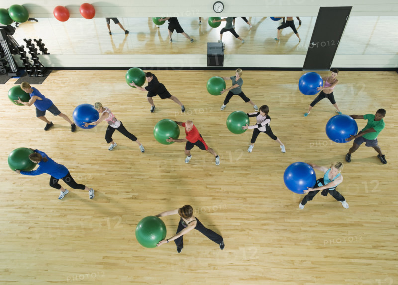 Fitness class holding balance balls. Date: 2008