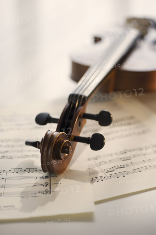 Violin laying on sheet music.