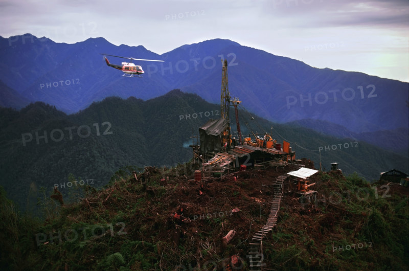 Helicopter flying over oil drilling platform in Indonesia. Date: 2008