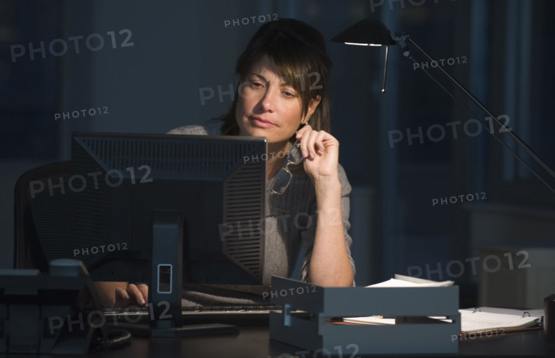 Businesswoman working late in office.