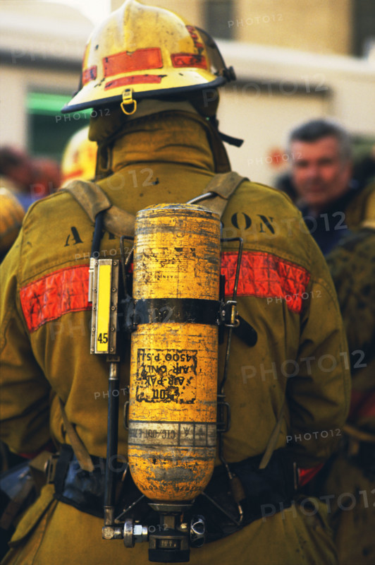 Rear view of fireman wearing oxygen tank. Date: 2008