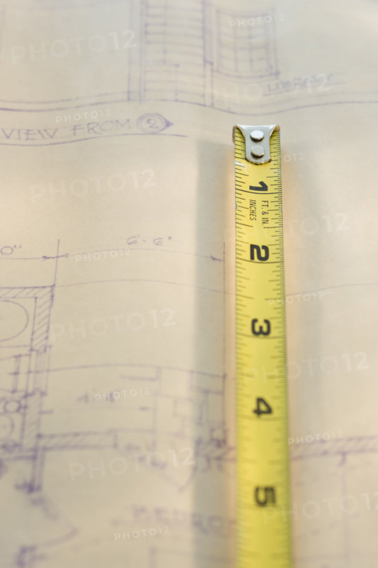 Tape measure on blueprint.