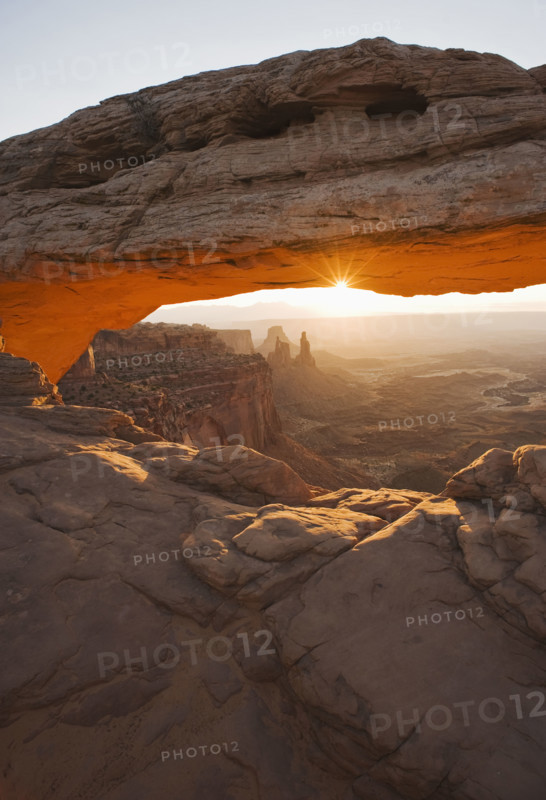 Sun shining behind Mesa Arch, Canyonlands National Park, Utah.