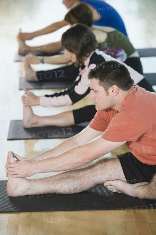 Fitness class stretching on mats. Date: 2008