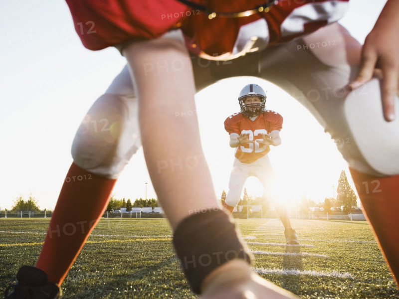 Football center preparing to snap football to quarterback. Date : 2008
