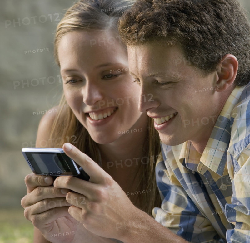 Close up of couple text messaging. Date: 2008