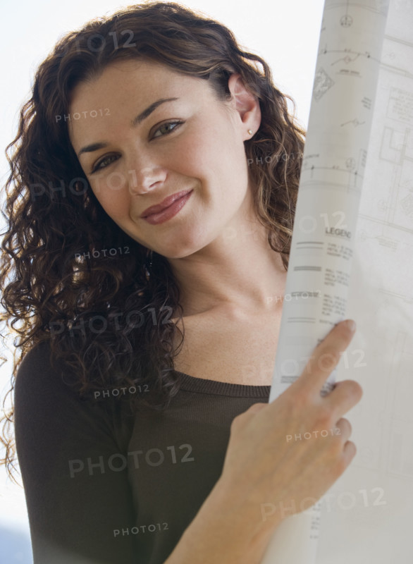 Close up portrait of architect holding blueprints.