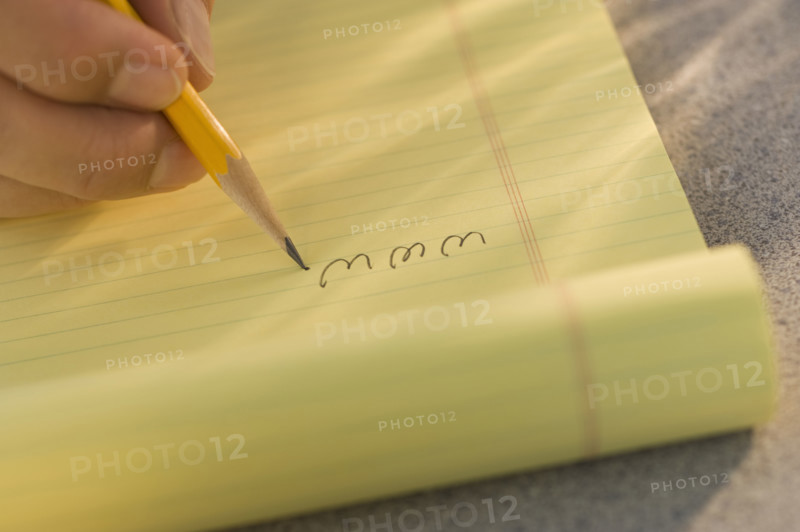 Man writing “www” on legal pad.