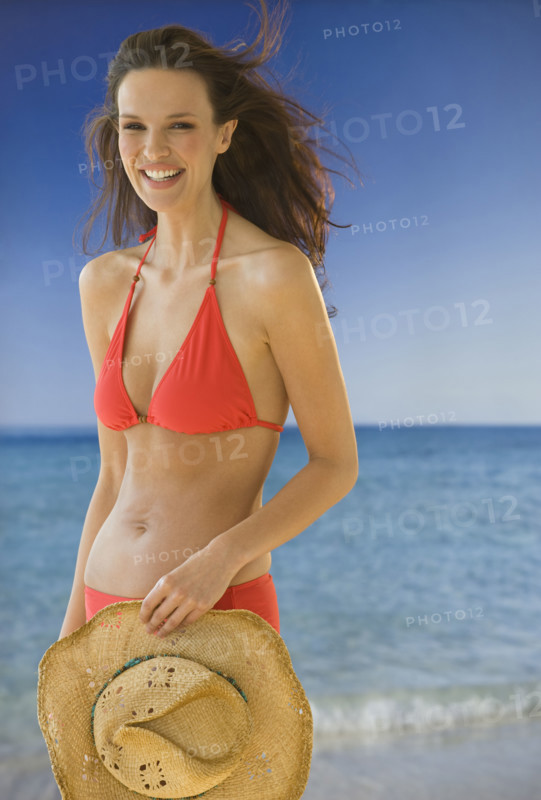 Portrait of woman in bikini on beach.