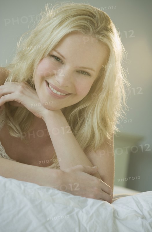 Woman relaxing on bed.