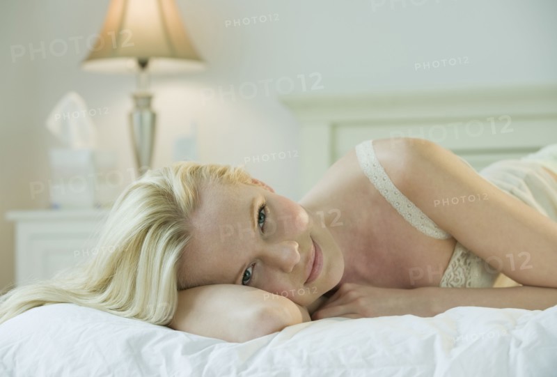 Woman relaxing on bed.
