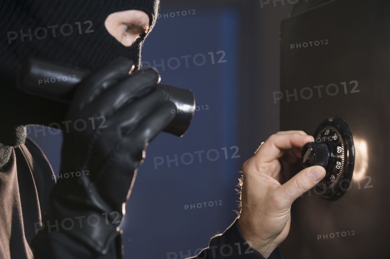 Burglar cracking safe.
