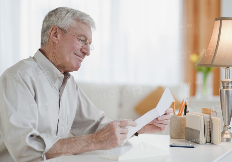 Senior man reading letter.