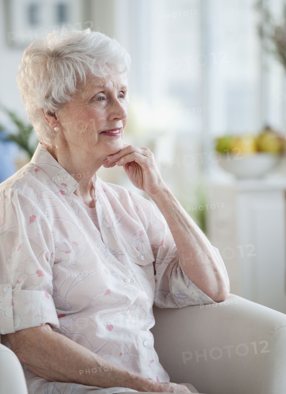 Senior woman sitting on sofa.