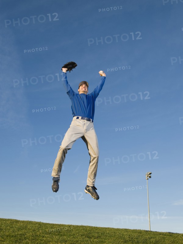 Baseball player jumping in air.