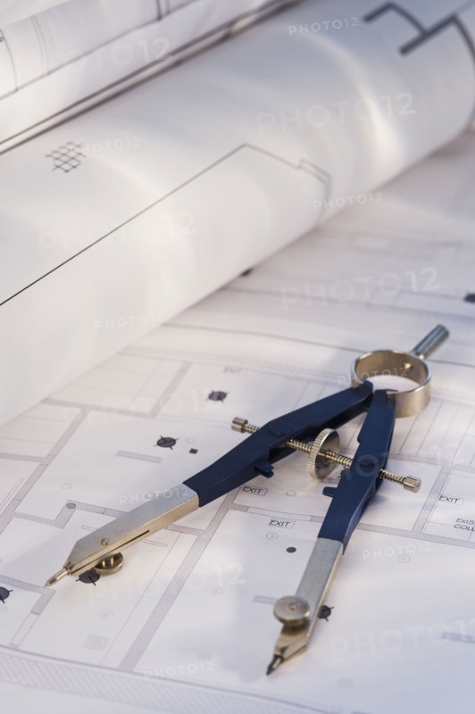 Drawing compass and blueprints. Photographe : Daniel Grill