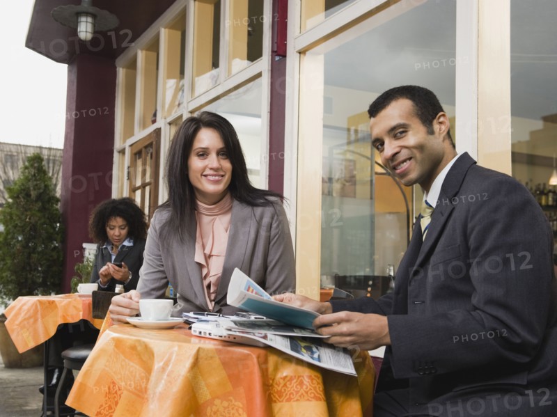 Businesspeople meeting at outdoor cafe.