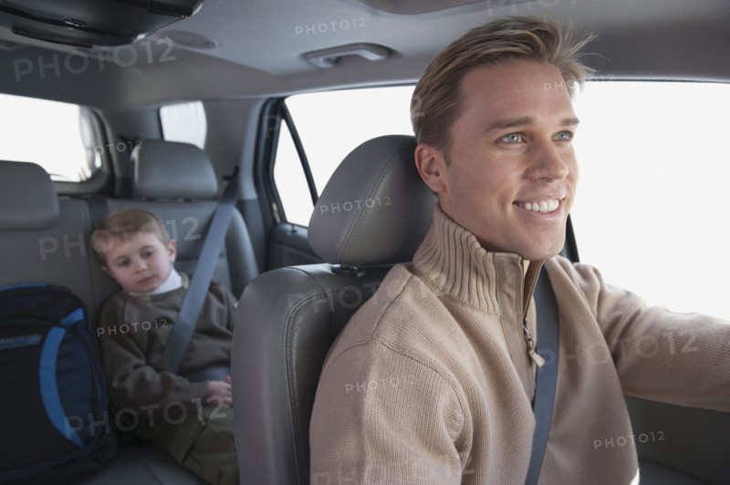 Father driving son to school.