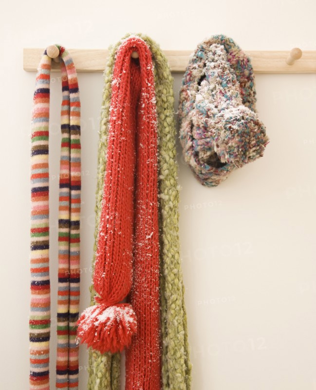 Snowy scarves hanging on rack. Photographe : Jamie Grill