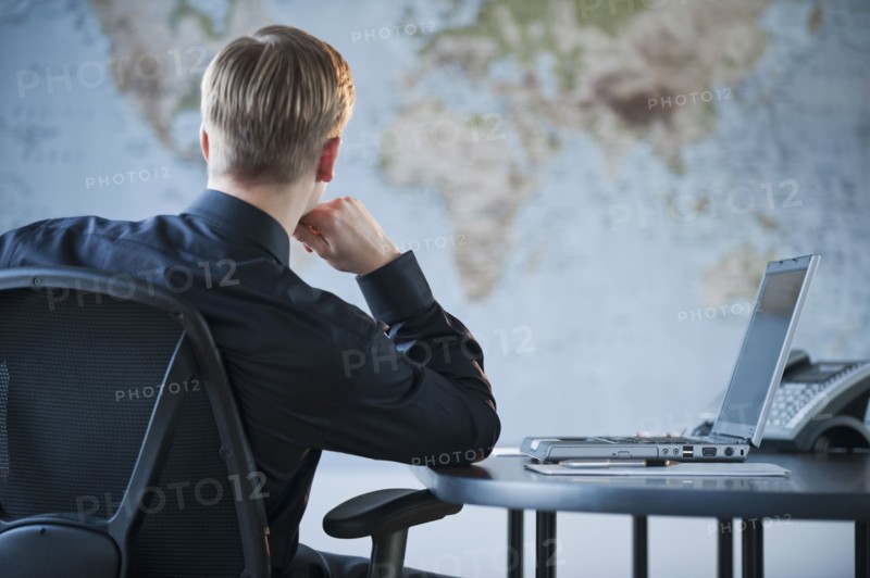 Businessman looking at world map.