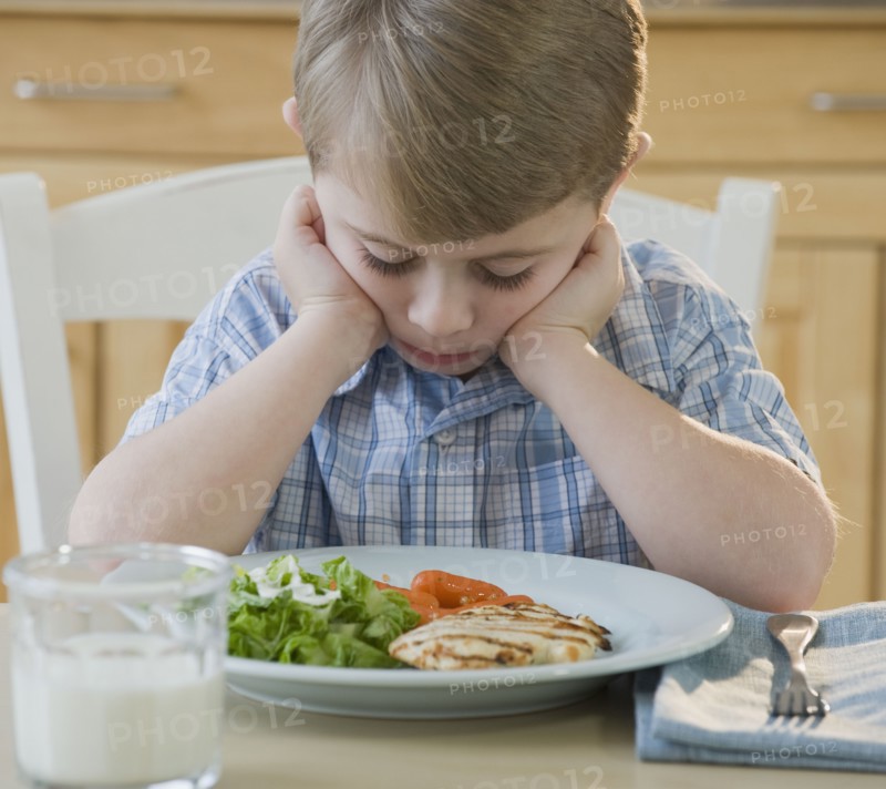 Boy looking at dinner.