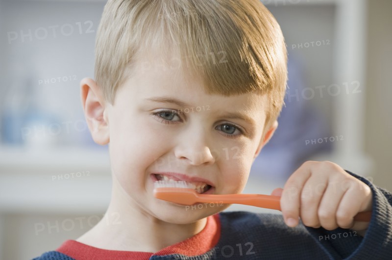Boy brushing teeth.