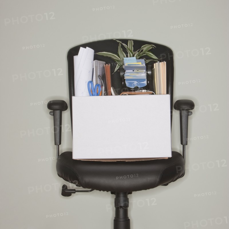 Packed box on office chair.