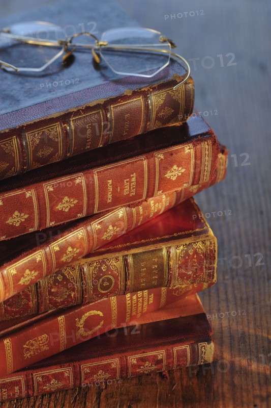 Antique books and eyeglasses.