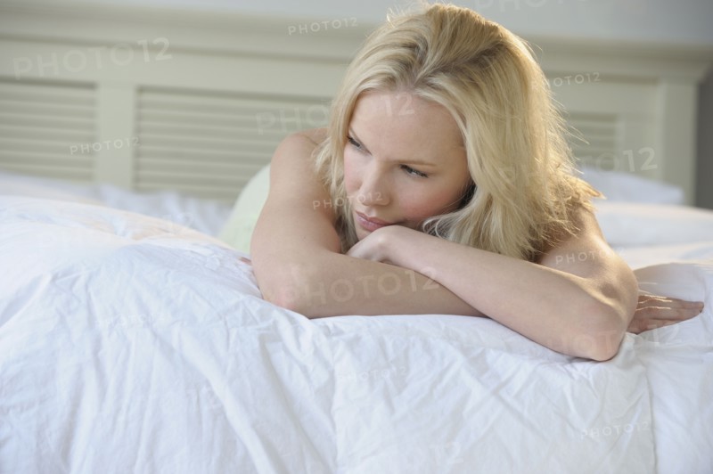 Woman relaxing on bed.