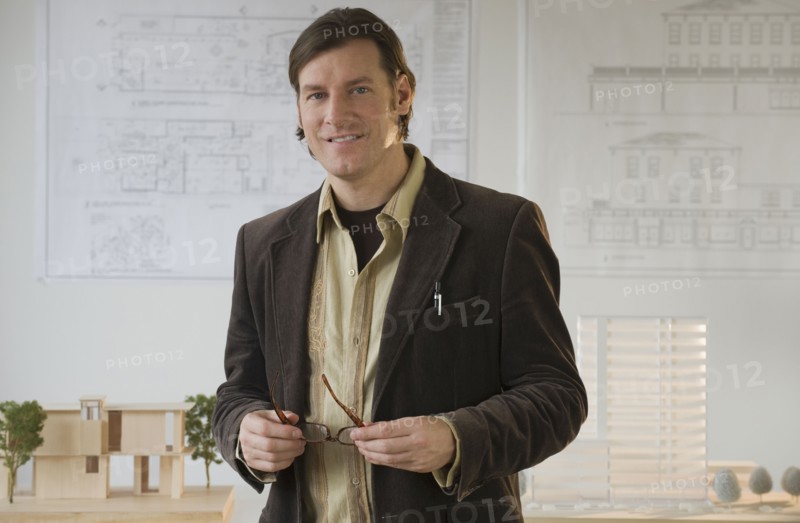 Architect posing in office.