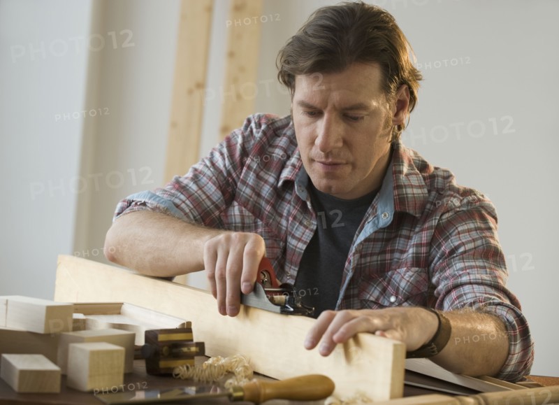 Man using woodworking tools.