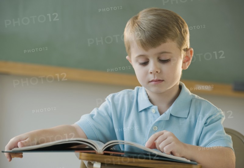 Boy reading book.