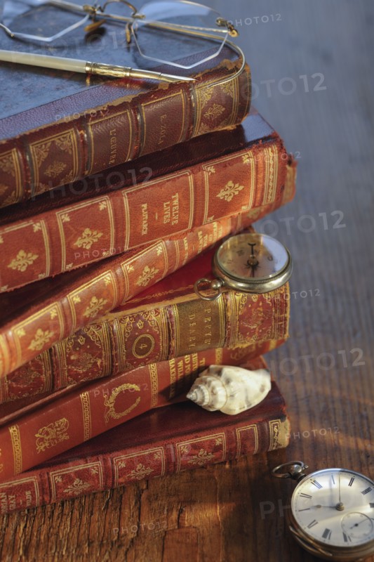 Antique books and compasses.