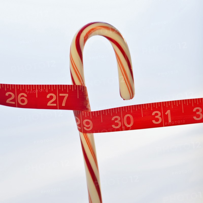 Measuring tape around candy cane.