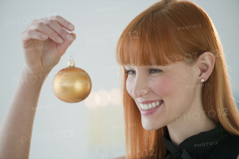 Woman holding Christmas ornament.
