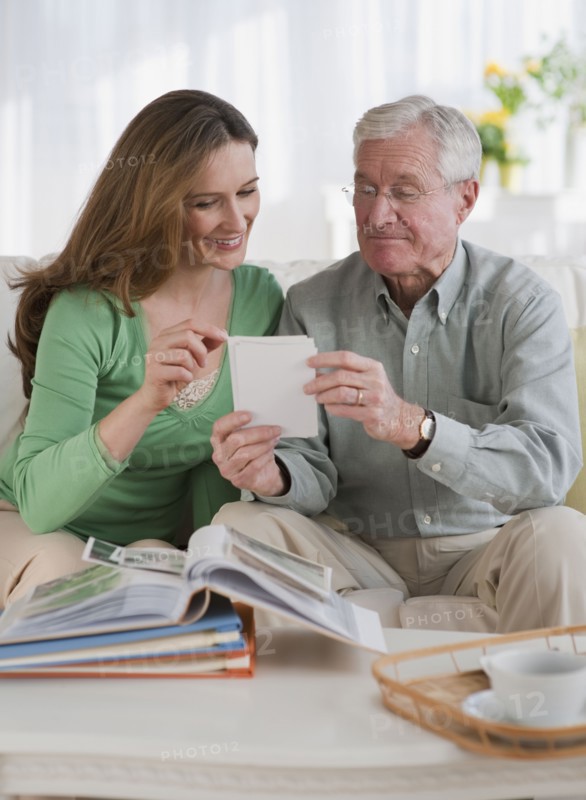 Father an daughter looking at photo albums.