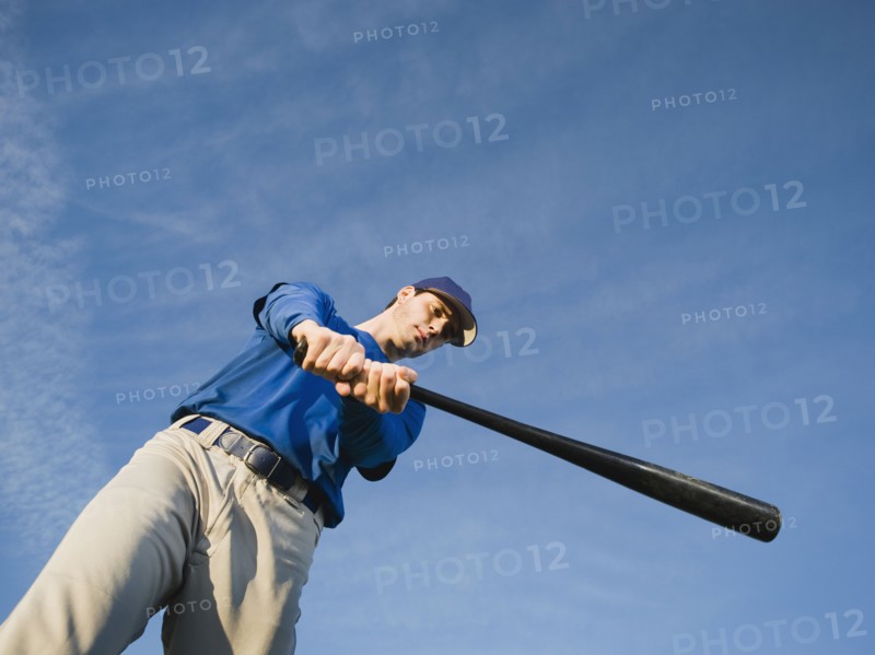 Baseball player swinging bat.