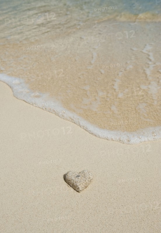 Heart shaped sand on beach.