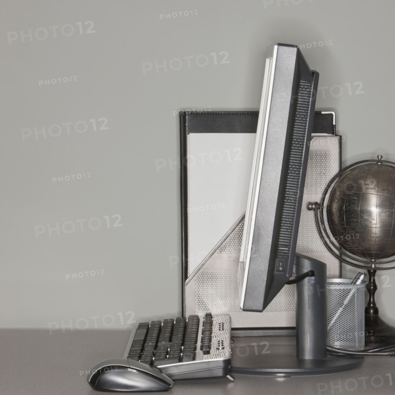 Computer and globe on office desk.