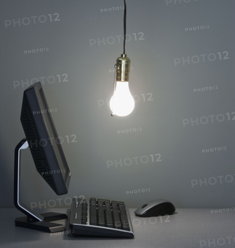 Light bulb hanging over computer.