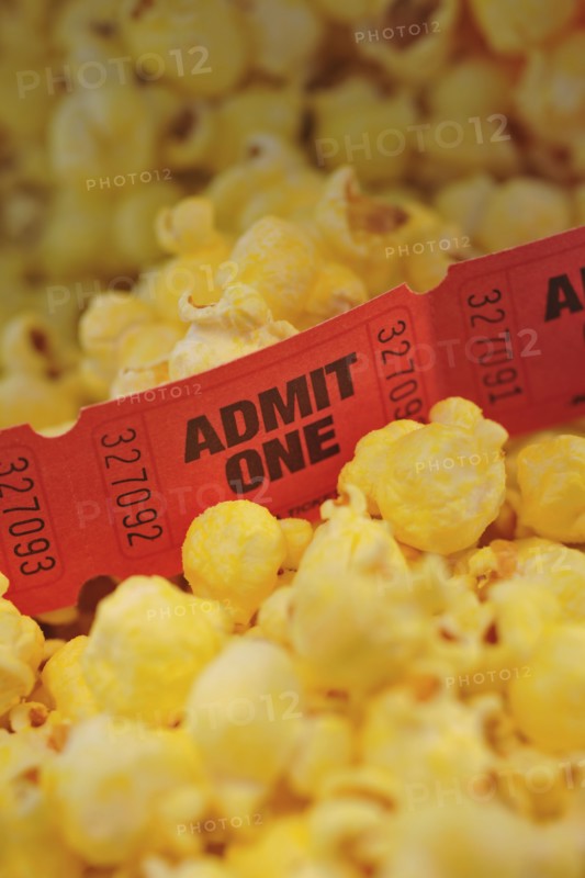 Close up of movie tickets and popcorn.