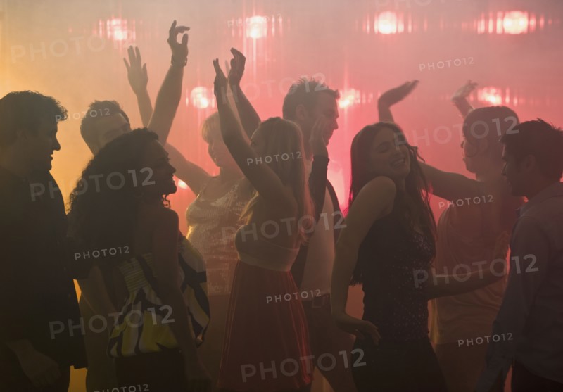 People dancing in nightclub.