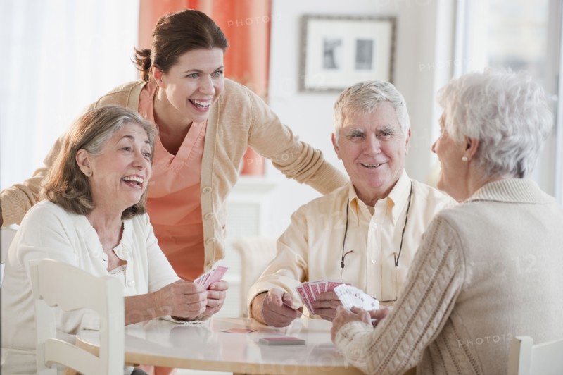 Senior adults playing cards.