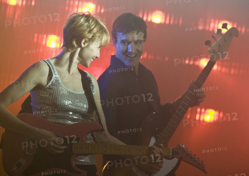 Performers playing electric guitars.
