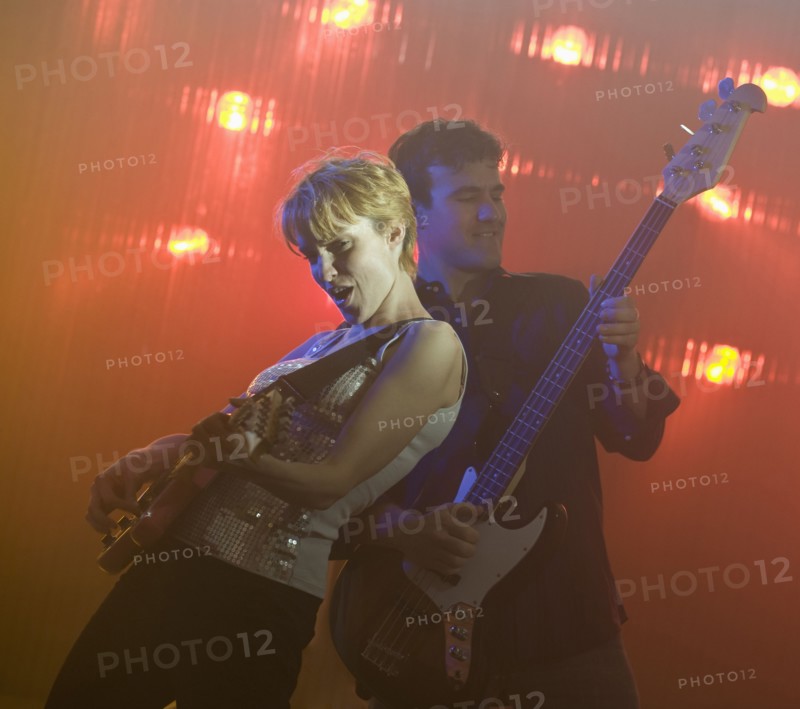 Performers playing electric guitars.