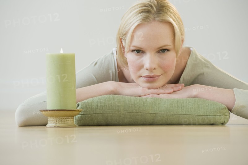 Woman relaxing with candle.