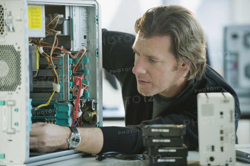Technician repairing computer.