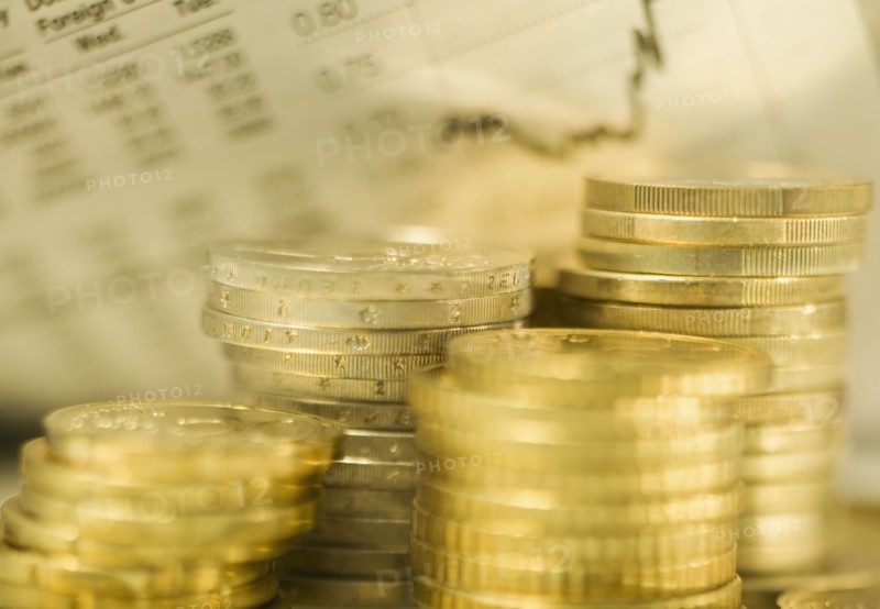 Stacks of euro coins and exchange rates.