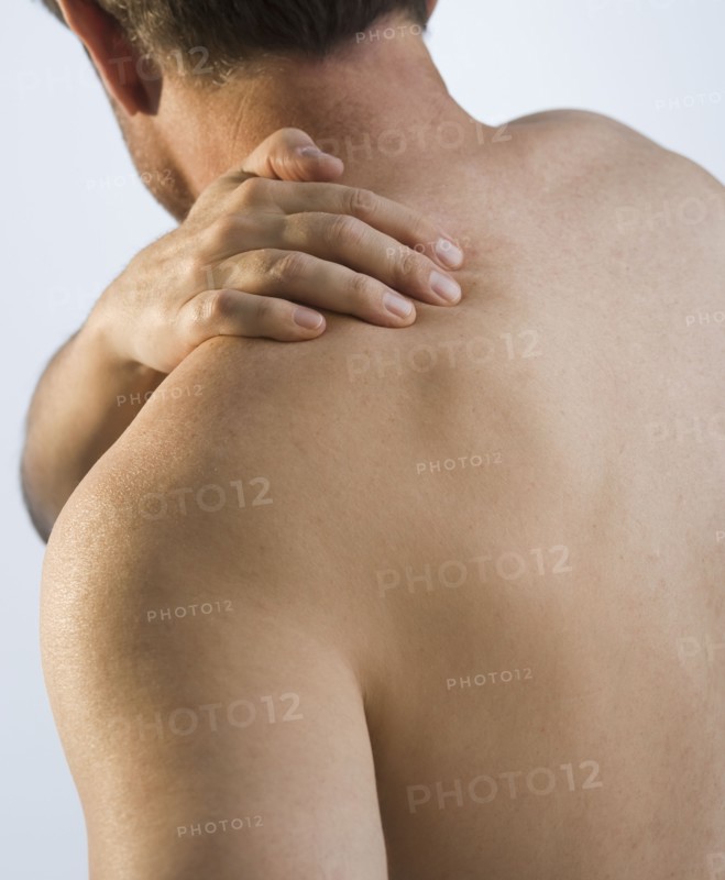 Man rubbing sore shoulder.